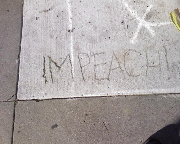 President Avoids Romanian Impeachment inscribed on a sidewalk.