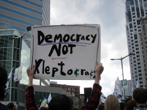 Democracy Not Kleptocracy sign New Constitution
