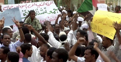 Sudan Protesters Arabic Signs International outrage to arrest Sudan's Bashir 