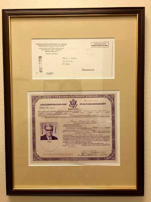Paul's father's naturalization papers from 1965,  hanging in his immigration law offices