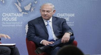 Netanyahu Vows to Stay On in Face of Charges